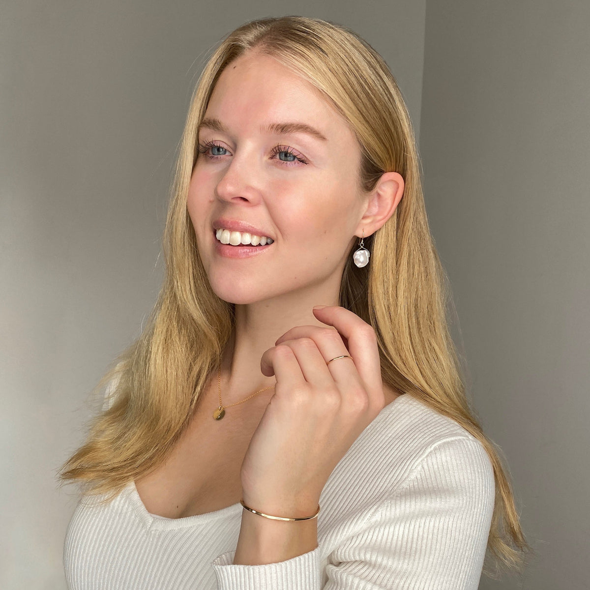 Model wearing 14k gold filled necklace, earrings, bracelet, and ring