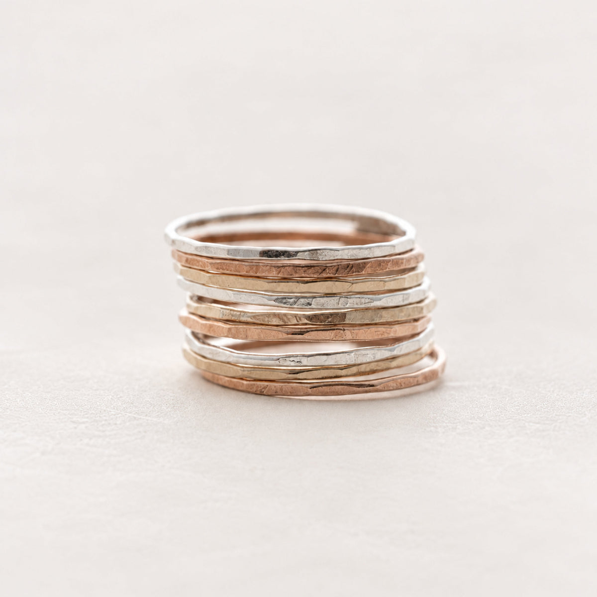 Stack of slim hammered rings in sterling silver, gold fill, and rose gold fill