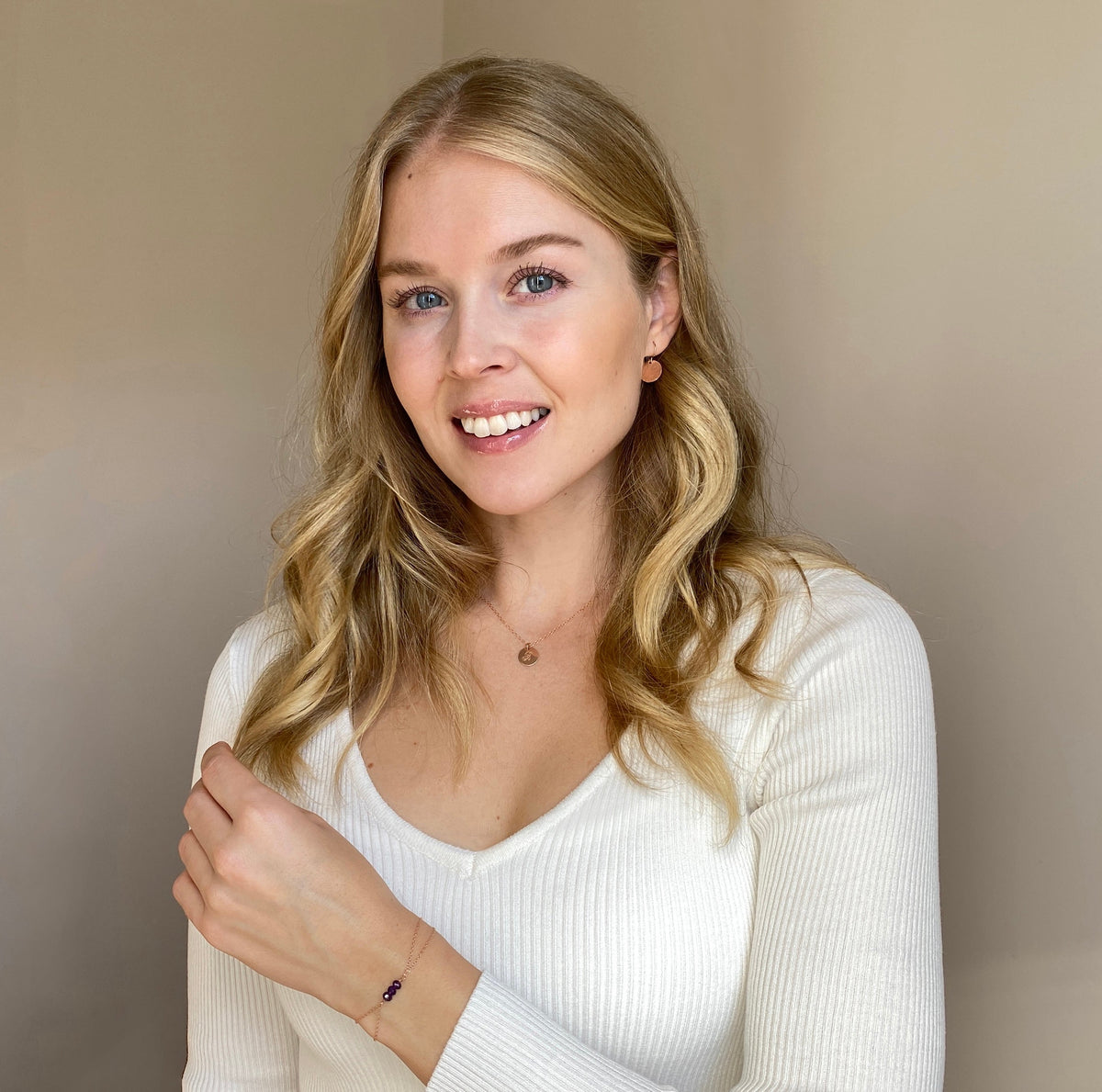 Model wearing 14k rose gold filled necklace, earrings, and gemstone bracelet