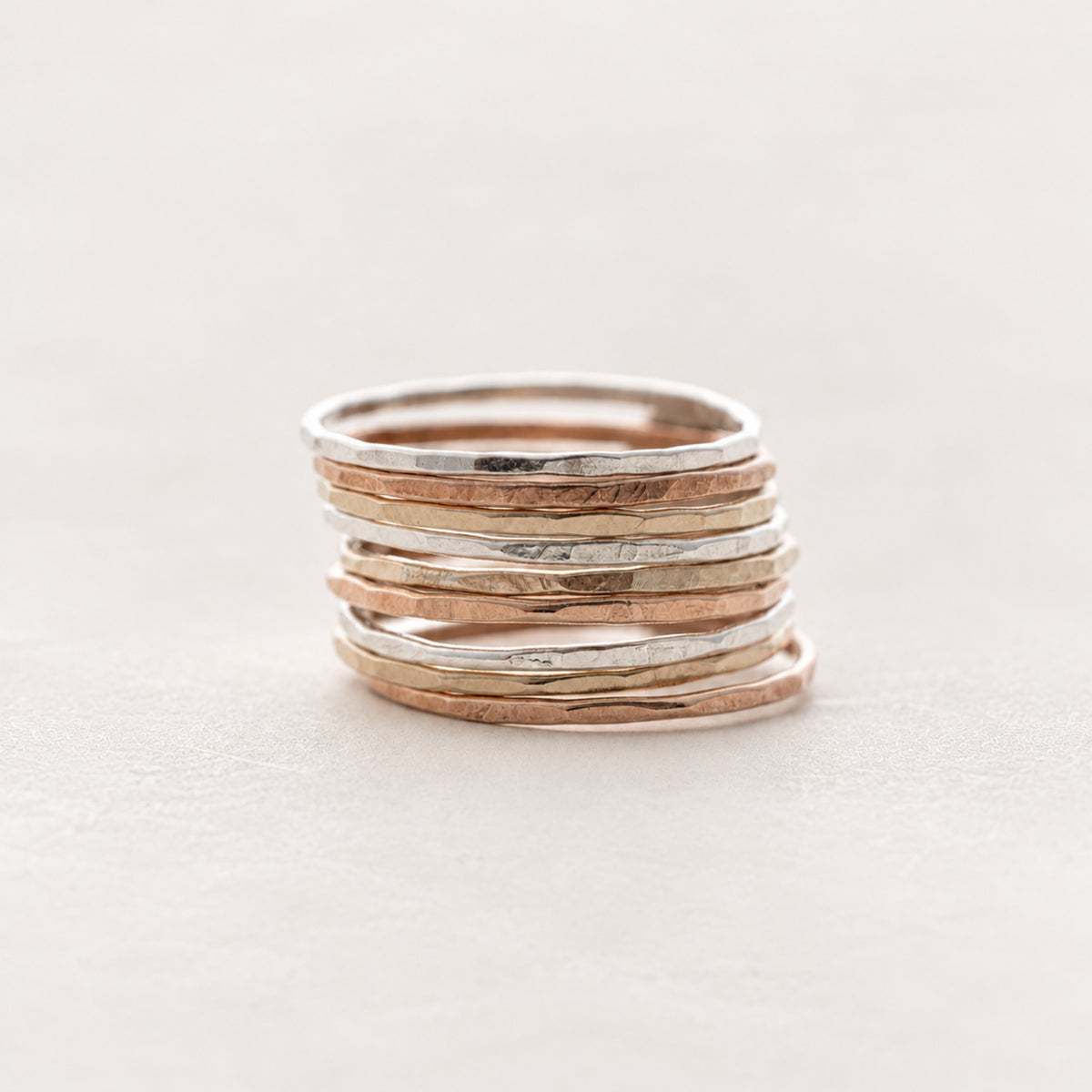 Stack of slim hammered rings in sterling silver, gold fill, and rose gold fill